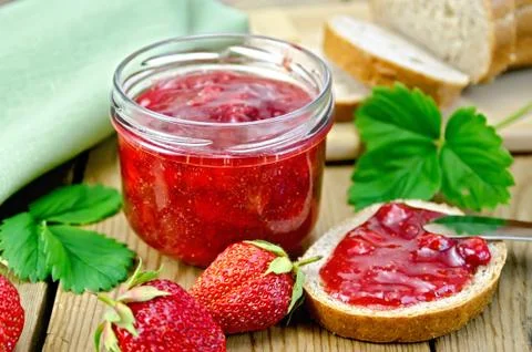 Jam strawberry with bread on the board Stock Photos