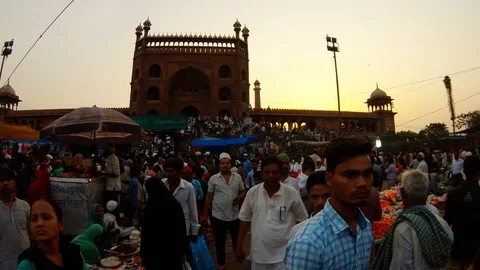 Jama Masjit mosque huge crowd in market near in rays of sunset Stock Footage 121761157