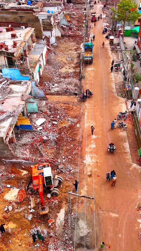 Jamnagar, India - 28 Aug 2026: Aerial view of demolished houses debris Video stock 343882286