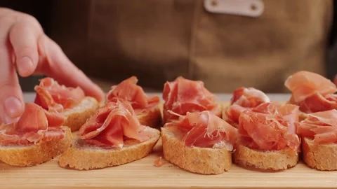 Jamon iberico tapas close up, chef cooking the best spanish ham pork tapas, cafe Stock Footage 246334409