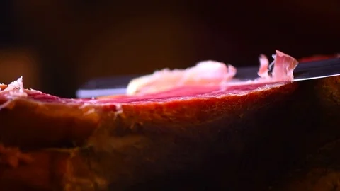 Jamon serrano. Slicing traditional spanish ham closeup Stock Footage