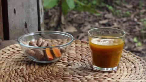 Jamu kunyit asam or kunir asam or tumeric tamarind juice Stock Footage 293426316