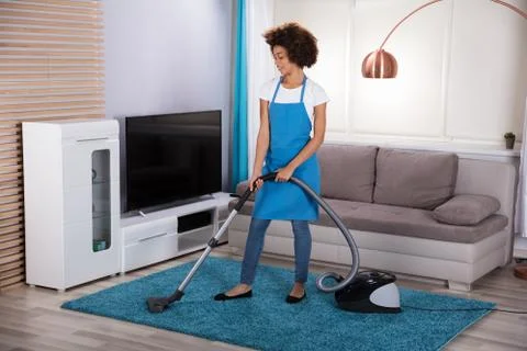 Janitor Cleaning Carpet With Vacuum Cleaner Stock Photos