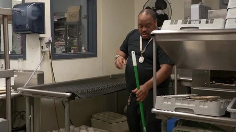 Janitor cleaning kitchen, medium shot (variant). Video stock 76721609