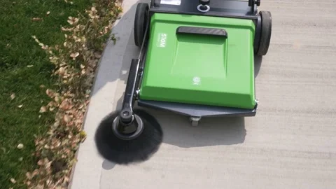 A janitor cleaning a walking path Stock Footage 171990477