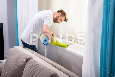 Janitor Cleaning Windowsill With Sponge Stock Photos