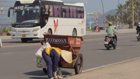 Janitor cleans the city from garbage using a big cart Video stock 241493459