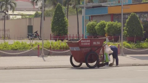 Janitor cleans the city from garbage using a big cart Video stock 241493533