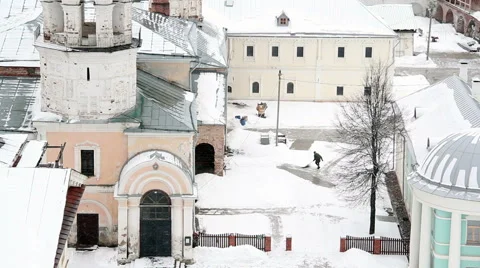 Janitor cleans snow in the yard of the monastery Stock Footage 61329355