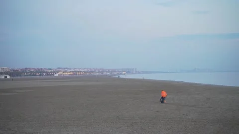 The janitor walks on the beach looking for trash (2) Video stock 138981631