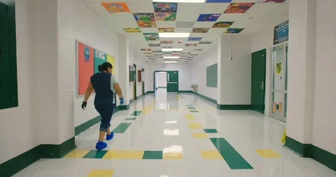 Janitor Walks Down School Hallway in Slow Motion Stock Footage