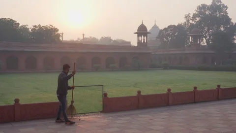 Janitor working at the Taj Mahal complex at sunrise, India Stock Footage 101232296