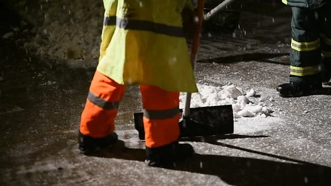 Janitors manually remove fresh snow from the sidewalk during snowfall 스톡 동영상 126971981