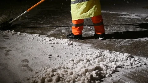 Janitors manually remove fresh snow from the sidewalk during snowfall 스톡 동영상 126972103