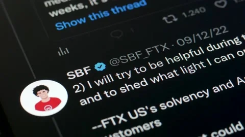 JANUARY 4, 2023: Scrolling Sam Bankman-Fried Twitter Profile Page on an iPhone Stock Footage 229119297