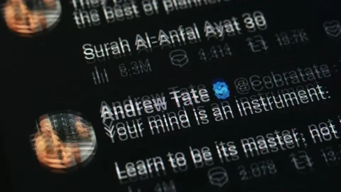 JANUARY 5, 2023: Scrolling Andrew Tate Twitter Profile Page on an iPhone Stock Footage 229274555