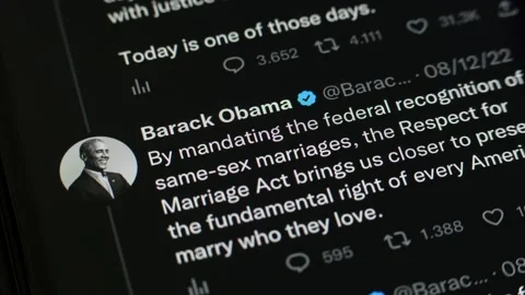 JANUARY 9, 2023: Scrolling Barack Obama Twitter Profile Page on an iPhone Stock Footage 229634612