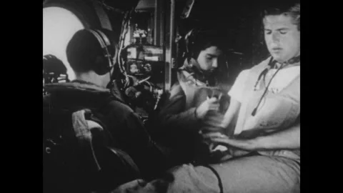 Japan 1940s: Crew members inside a B-29 Superfortress bomber wearing headsets Stock Footage 344138521
