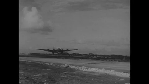 Japan 1940s: Four-engine B-29 bomber flies low over an airfield with clouds Stock Footage 344138426
