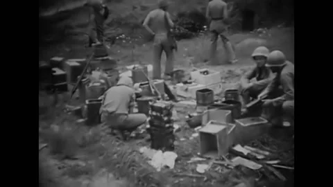 JAPAN - 1945 - US marines load ammunition onto tanks near wrecked Japanese Stock Footage 287744462