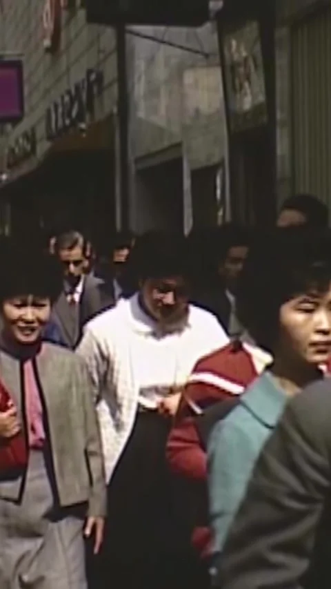 JAPAN - 1963 - Commuters leave a train station and crowd the sidewalks of Tokyo, Stock Footage 339102997