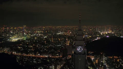 Japan Tokyo Aerial v170 Flying low around clock tower with cityscape views night Stock Footage