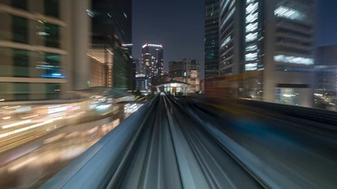 Japan Tokyo train moving through the city timelapse at night Stock Footage 116662665