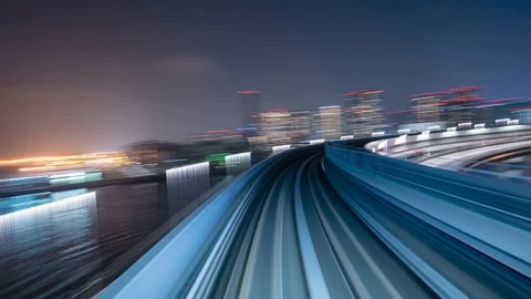 Japan Tokyo train moving through the city timelapse at night Video stock 118972930