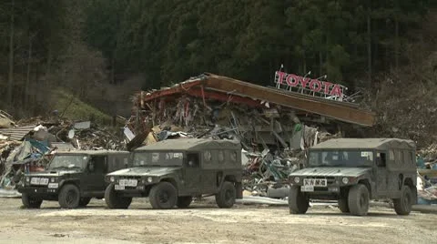 Japan Tsunami Aftermath - Military Vehicles Parked Outside Destroyed Building Stock Footage