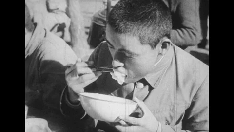 JAPAN: young man eats rice from bowl. Man drinks tea. Man blows bugle. Stock Footage