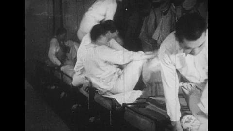 JAPAN: young men change into uniforms. Rice served into steaming bowls. Stock Footage