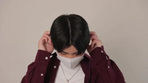 Japanese boy feels disappointed to keep his mask on. Stock Footage 220757150