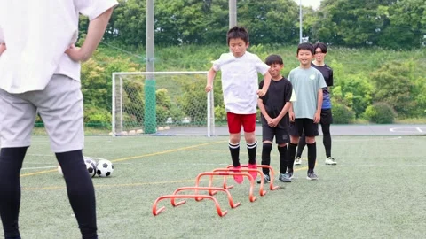 Japanese Boy Jumping Over Agility Hurdles During Soccer Training 스톡 동영상 344240711