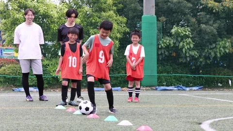 Japanese Boy Practicing Soccer Dribbling Through Training Markers Stock-Footage 344240885