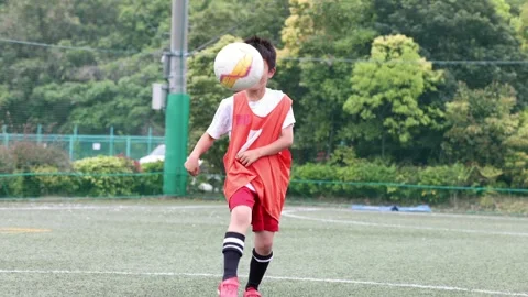 Japanese Boy Practicing Soccer Juggling on Outdoor Field 動画素材 344241334
