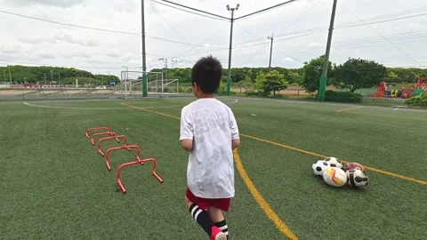 Japanese Boy Preparing for Agility Hurdle Drill During Soccer Training Stock Footage 344241449