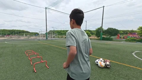 Japanese Boy Preparing for Agility Hurdle Drill During Soccer Training Vídeos de archivo 344241477