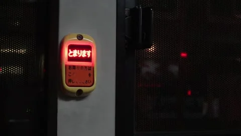Japanese bus stop chime button glowing red at night. Stock Footage 345361838