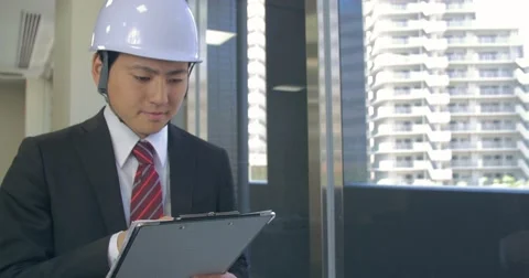 Japanese business man checking safty standards on building project Stock Footage 63431843