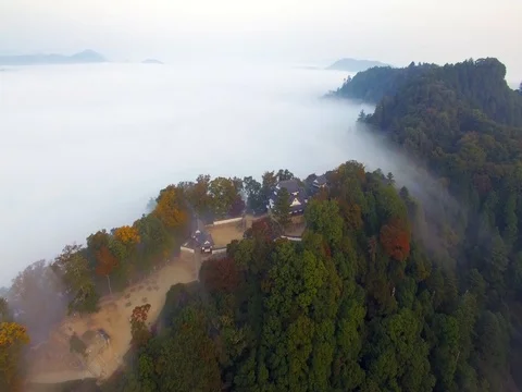 Japanese Castle in a Sea of Clouds Stock Footage 75458052