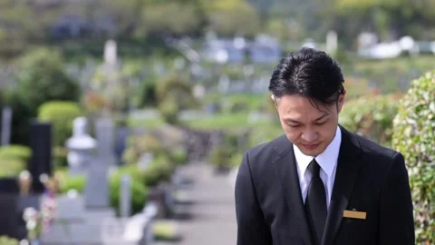 Japanese Cemetery Staff Bowing Respectfully at Memorial Park Vídeos de archivo 344123368