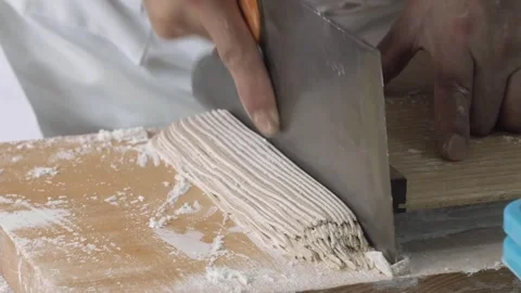 Japanese Chef Hand-Cutting Fresh Soba Noodles with Traditional Cleaver Stock Footage 333523722