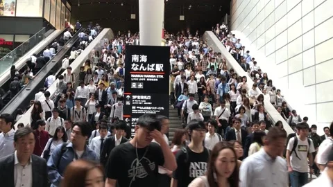 Japanese commuters walking trough large stairs in rush hour in the early morning Stock Footage