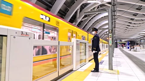 Japanese conductor or Train driver give hand signal to the driver  Video stock 189491168