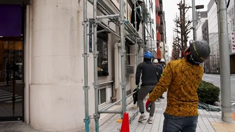 Japanese Construction Workers Assembling Scaffolding on Tokyo Sidewalk Stock Footage 343352904