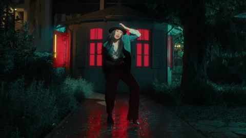 Japanese Dancer with a hat in front of a house with red light in it Stock Footage 274944745