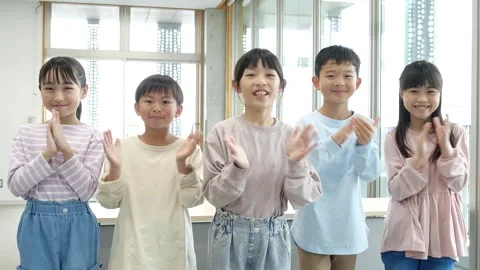 Japanese Elementary School Children Smiling and Clapping in Classroom Stock Footage 344097088