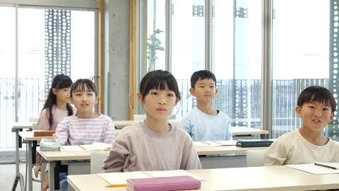 Japanese Elementary School Students Raising Hands in Classroom Stock Footage 344093943