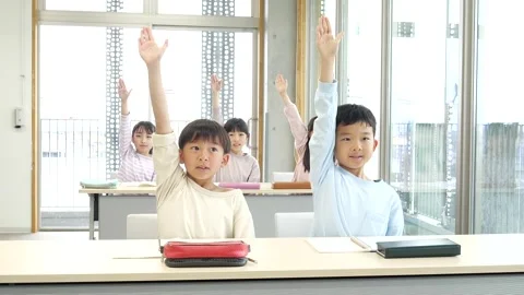 Japanese Elementary School Students Raising Hands in Classroom Stock Footage 344094454
