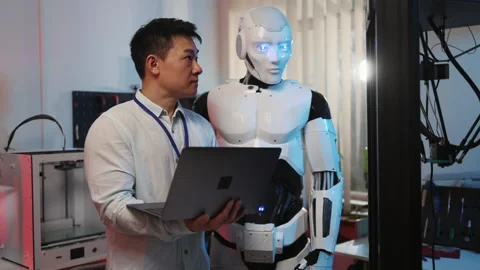 Japanese engineer with robot discovering automated 3d printing creating plastic Stock Footage 153744498